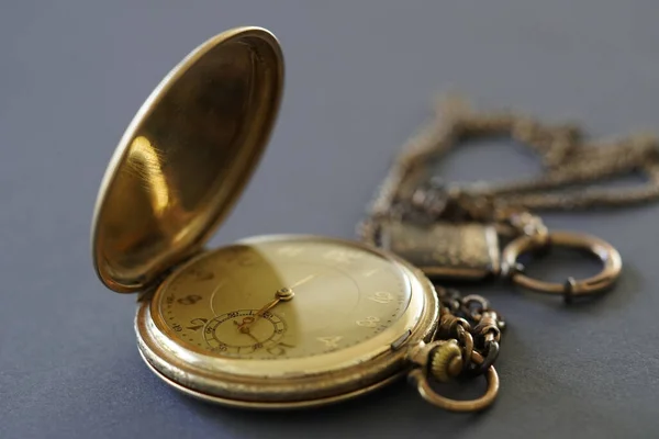Gri Bir Yüzeyde Eski Bir Altın Saatin Yakın Çekimi — Stok fotoğraf