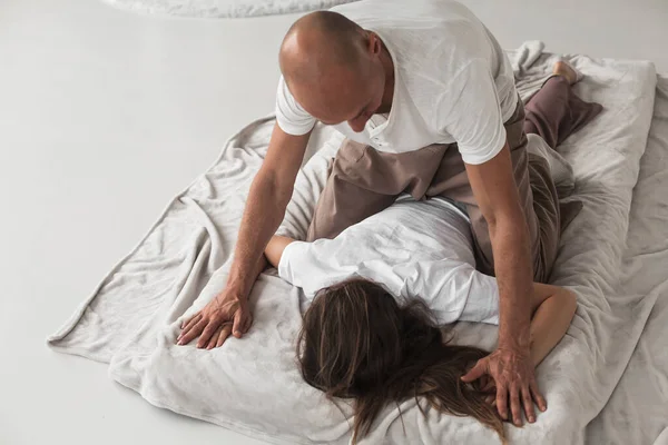 Professional Young Man Fixing Woman Shoulders White Cozy Room Manual — Foto Stock