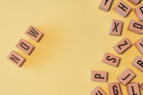Word Now Taken Pile Wooden Letter Blocks Yellow Background Copy — Fotografia de Stock