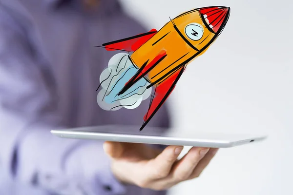 A 3D rendering of a space rocket icon floating on a man\'s tablet