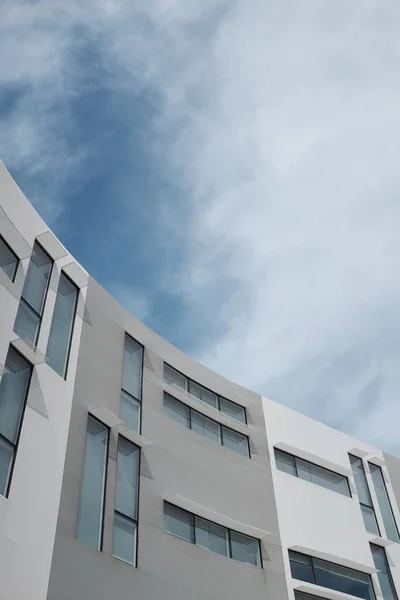 stock image A beautiful shot of a modern building with a cloudy sky in the background