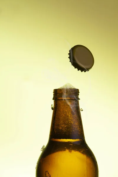 Vertical Shot Beer Bottle Opening Isolated Light Golden Background — Stock Photo, Image