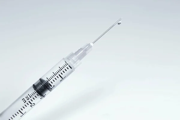 Closeup Shot Medical Syringe Filled Liquid Squirting Out Needle White — Stock Photo, Image