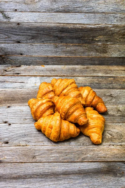 Vertikální Záběr Chutných Croissantů Dřevěném Stole — Stock fotografie