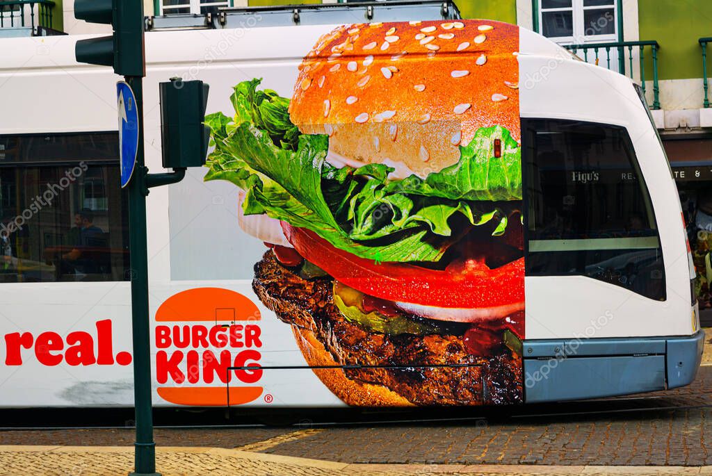 LISBOA, PORTUGAL - Oct 16, 2021: Rossio,Lisboa,Portugal, October 16 2021: This is a modern tram 15E, which connects Baixa with Belem.Some trams advertise things like Burger King