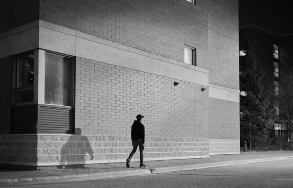 Grayscale Shot Man Walking Street Eveni — Stock Photo, Image