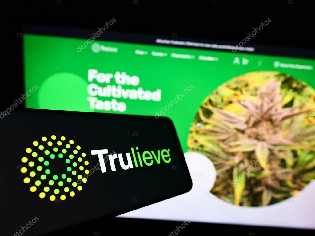STUTTGART, GERMANY - Dec 13, 2021: Cellphone with logo of medical marijuana company Trulieve Cannabis Corp. on screen in front of website. Focus on center-left of phone display.