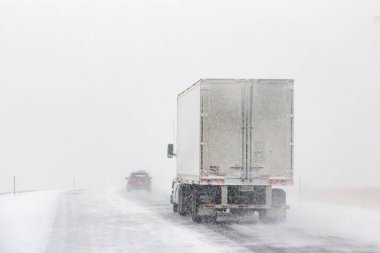 The winter road conditions with vehicles on I-80 in Southern Wyoming near Vedauwoo and Buford, WY clipart