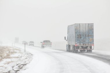 The winter road conditions with vehicles on I-80 in Southern Wyoming near Vedauwoo and Buford, WY clipart