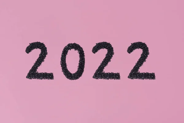 Die Schrift 2022 Die Mit Glitzern Auf Einer Rosafarbenen Oberfläche — Stockfoto