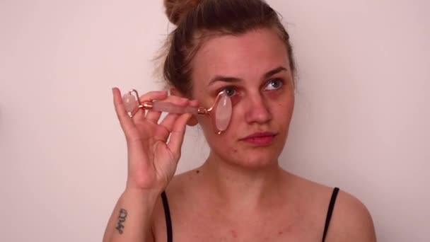 Young Blonde Woman Doing Face Massage Studio — стоковое видео