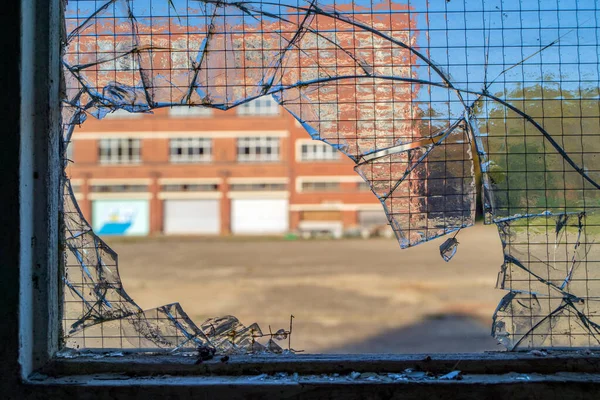 Tiro Close Copo Quebrado Uma Janela Com Vista Edifício Laranja — Fotografia de Stock