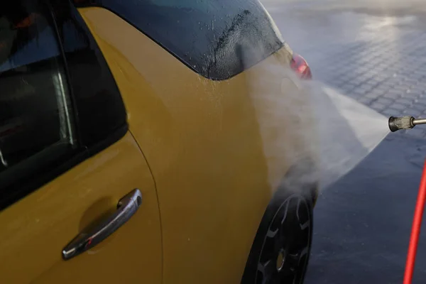 洗車場で黄色の車を洗う者 — ストック写真