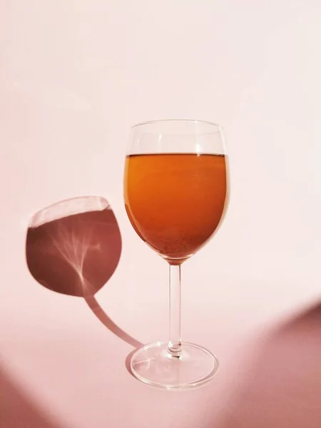 Copa Vino Tinto Con Una Rosa Sobre Fondo Rosa — Foto de Stock