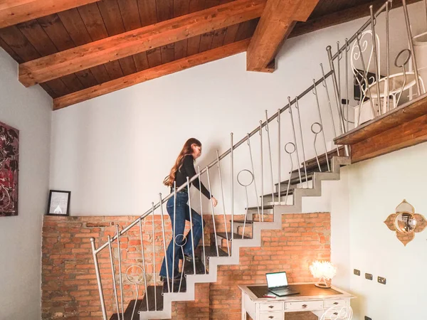 young woman on the stairs at home
