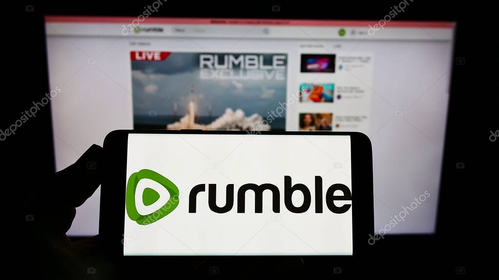 Rumble logo on smartphone screen and computer monitor