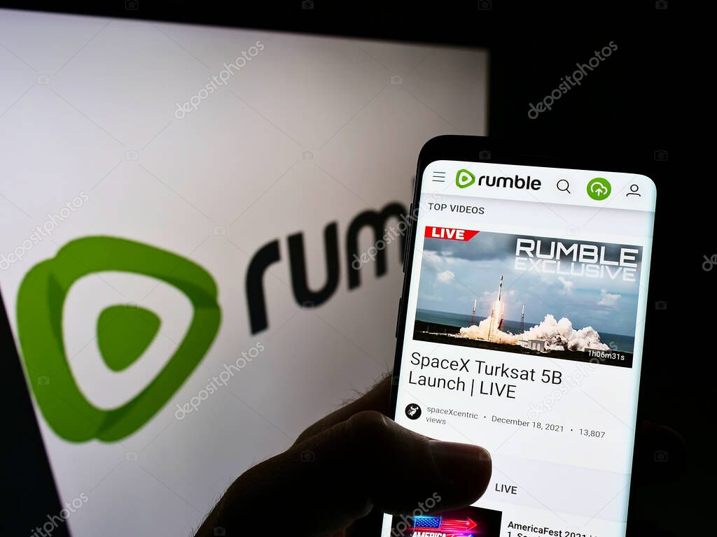 Rumble logo on smartphone screen and computer monitor