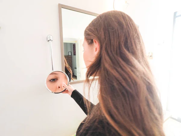 Young Woman Mirror Her Hair — стоковое фото