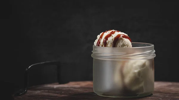 Stock image chocolate ice cream in a glass bowl on a black background.