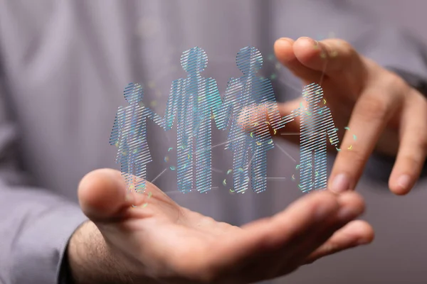 An abstract shot of male hands displaying 3D rendered family icons, adoption, foster care