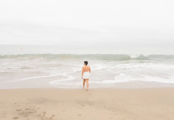 woman on the private beach of Punta Centinela in Ecuador