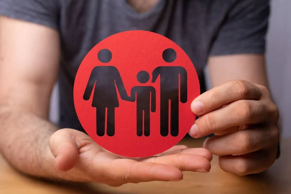 Closeup Person Holding Red Sign Family Figures Family Insurance Concept — стоковое фото