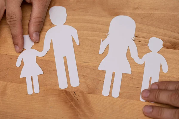 An abstract shot of female hands displaying 3D rendered family icons,children protection and care