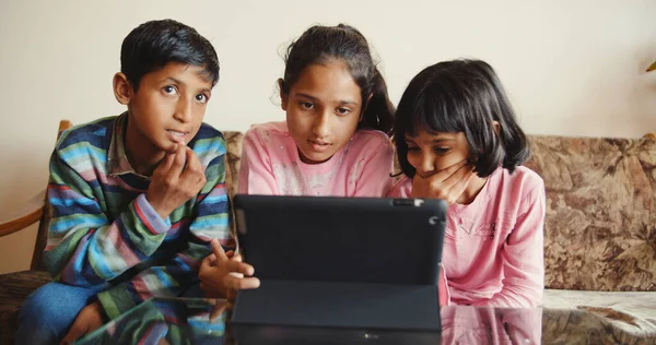 Three South Asian Kids Sitting Together Front Tablet — стоковое фото