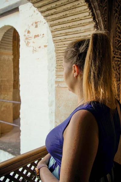 young woman looking at the landscape with blue dress and collected hair