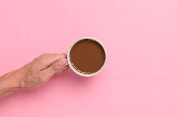 Top View Hand Holding Coffee Mug Pink Background — Zdjęcie stockowe