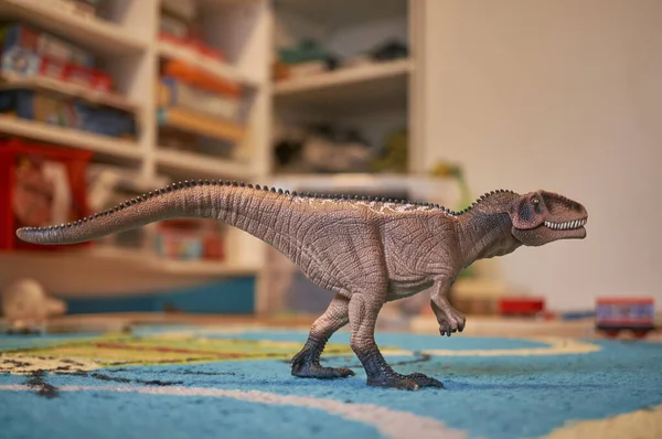 dinosaur toy on the floor in house