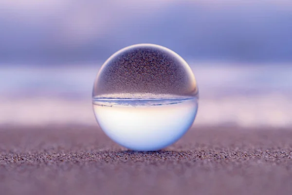 close up of a glass ball on the beach