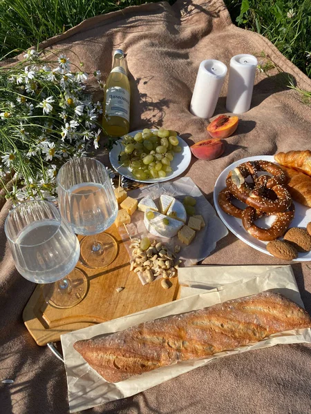 stock image picnic table with bread, cheese and flowers