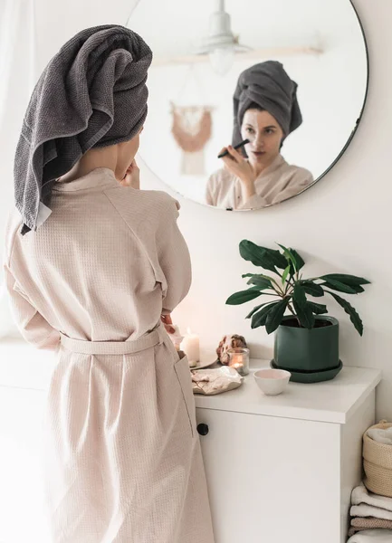 Beautiful Young Woman Bathrobe Towel Her Face Looking Camera While — Stock Photo, Image
