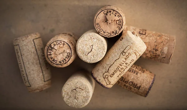 wine corks and cork on wooden background