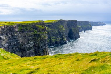 beautiful icelandic landscape with cliffs and green grass clipart