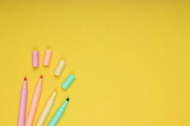 colored pencils. back to school. Isolated yellow background