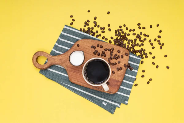 Filter coffee with milk on wood standing and coffee beans. Isolated background