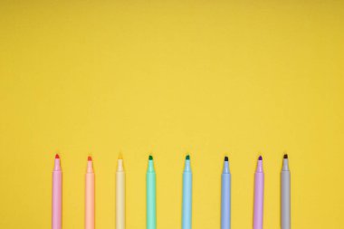 colored pencils. back to school. Isolated yellow background