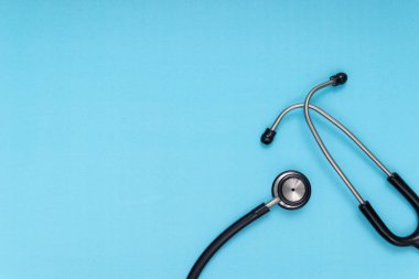 black stethoscope, blue isolated background