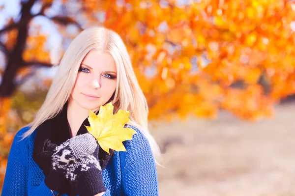 Woman with yellow leaf outdoors — Stock Photo, Image