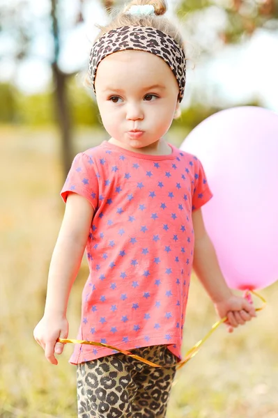 Baby girl with balloon — Stock Photo, Image
