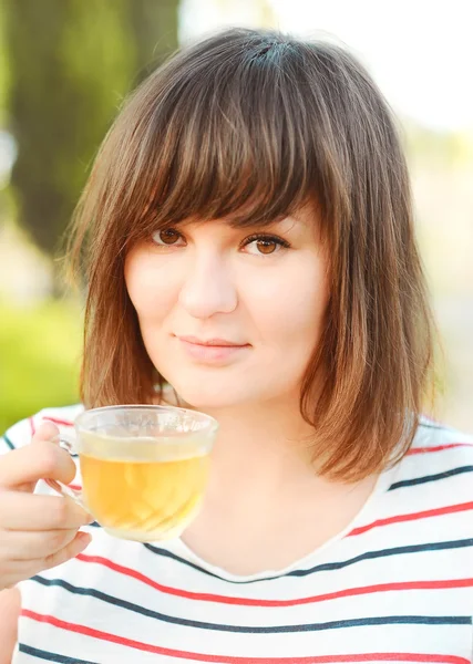 Pretty woman drinking orange juice — Stock Photo, Image