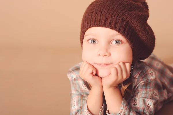 Cute little girl wearing knitted hat in studio — Stock Photo, Image