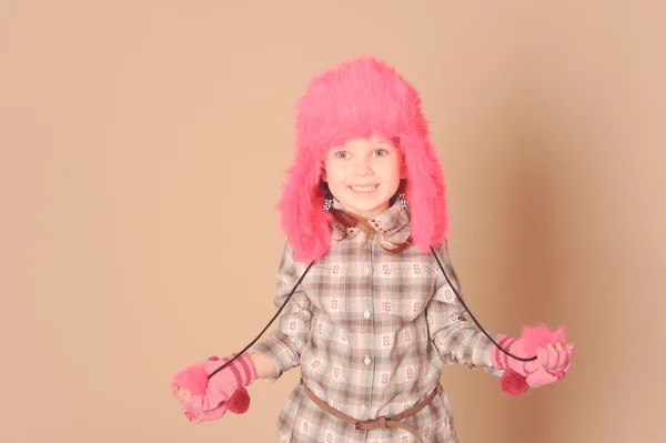 Cute little girl wearing fur hat in studio — Stock Photo, Image