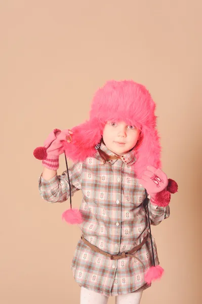 Cute little girl wearing fur hat in studio — Stock Photo, Image
