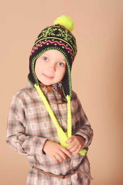 Cute young model wearing knitted hat in studio — Stock Photo, Image