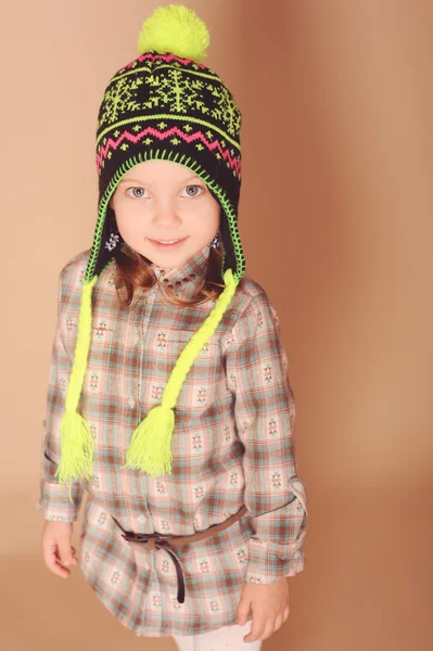 Cute young model wearing knitted hat in studio — Stock Photo, Image