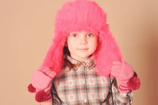 Cute baby girl wearing fur hat in studio — Stock Photo, Image