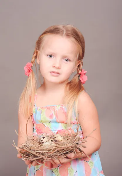 Girl holding nest — Stock Photo, Image